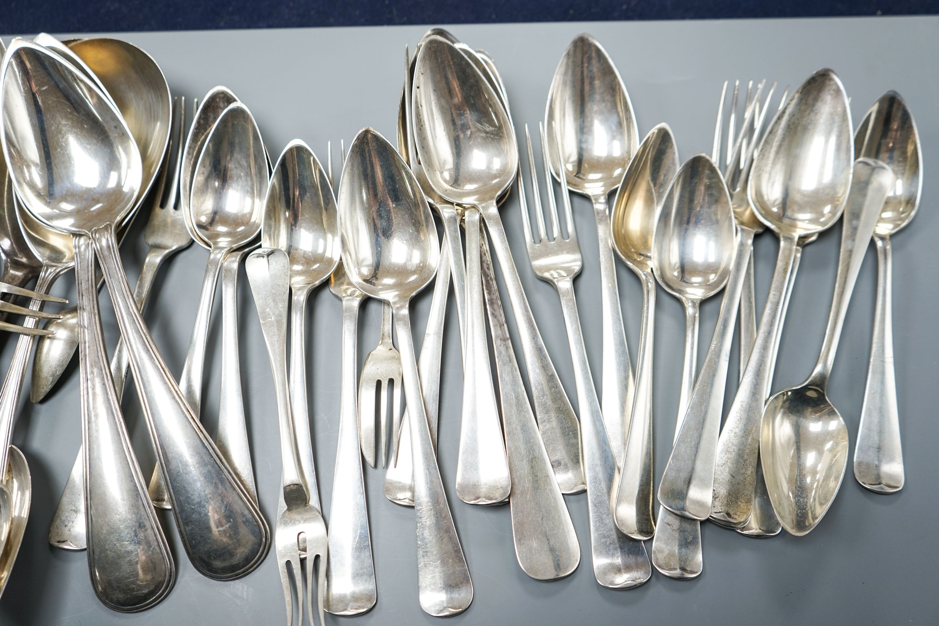 A quantity of assorted mainly Dutch white metal flatware including a part canteen, five English silver cake forks and two plated spoons